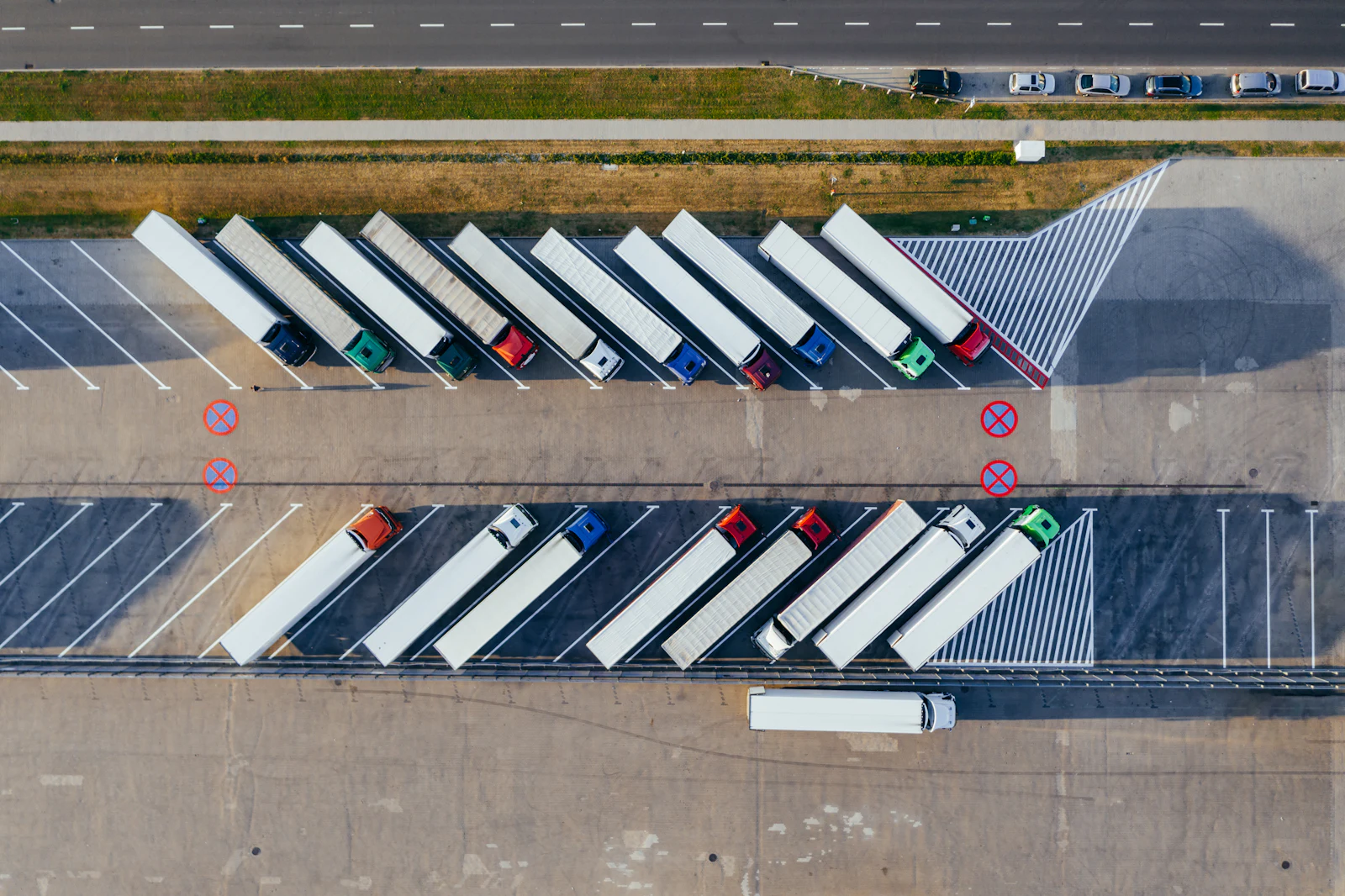 Aerial view of tractor-trailers parked in a freight yard.